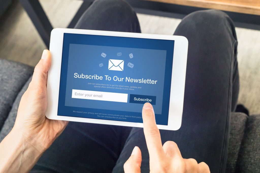 Person subscribing to a newsletter on a tablet.